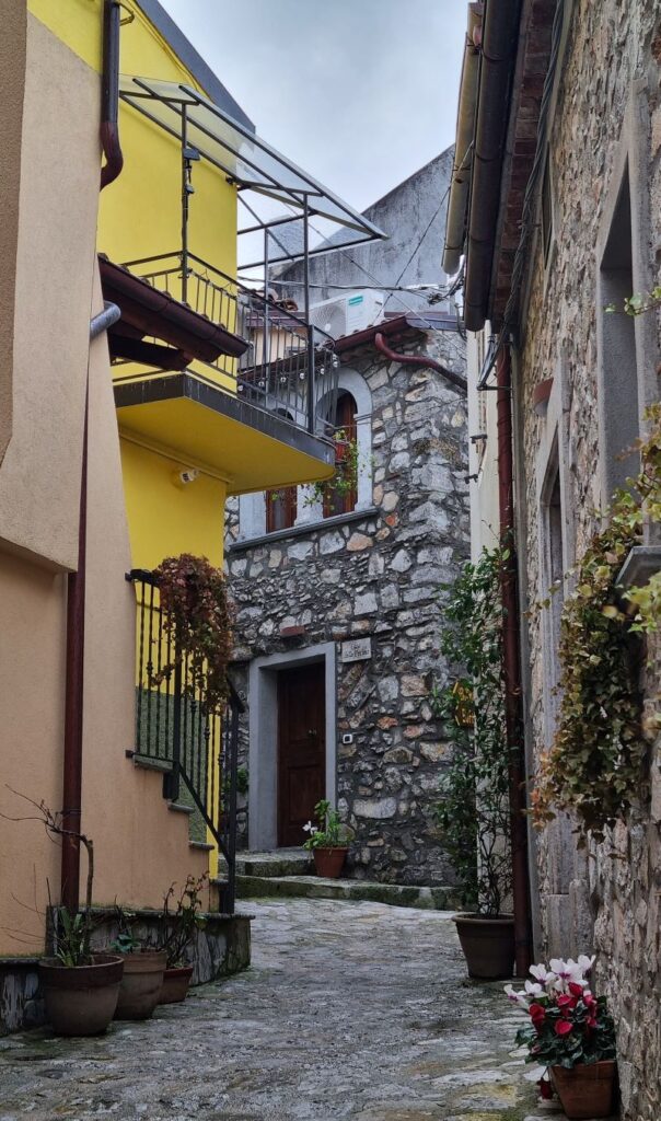 Calle del centro histórico de Rotonda con casas de piedra y balcones tradicionales en Basilicata