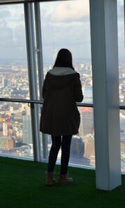 Silueta de una persona de espaldas observando las vistas panorámicas de Londres desde las plantas superiores del rascacielos The Shard, con el skyline de la ciudad visible a través de los ventanales